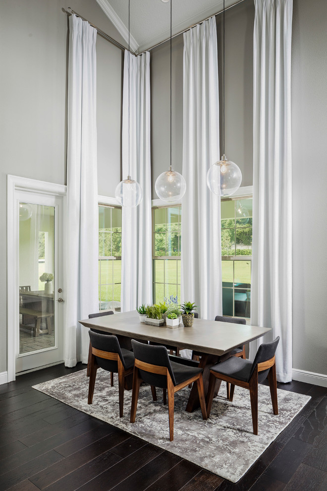 Design ideas for a transitional dining room in Orlando with grey walls, dark hardwood floors and brown floor.