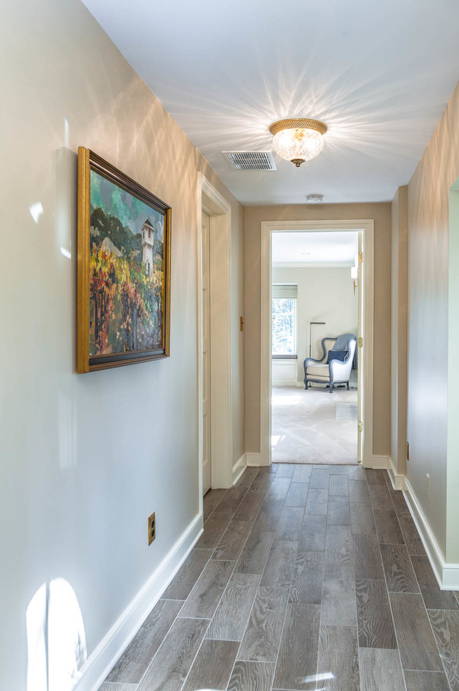 Photo of a large country hallway in Indianapolis with beige walls and porcelain floors.