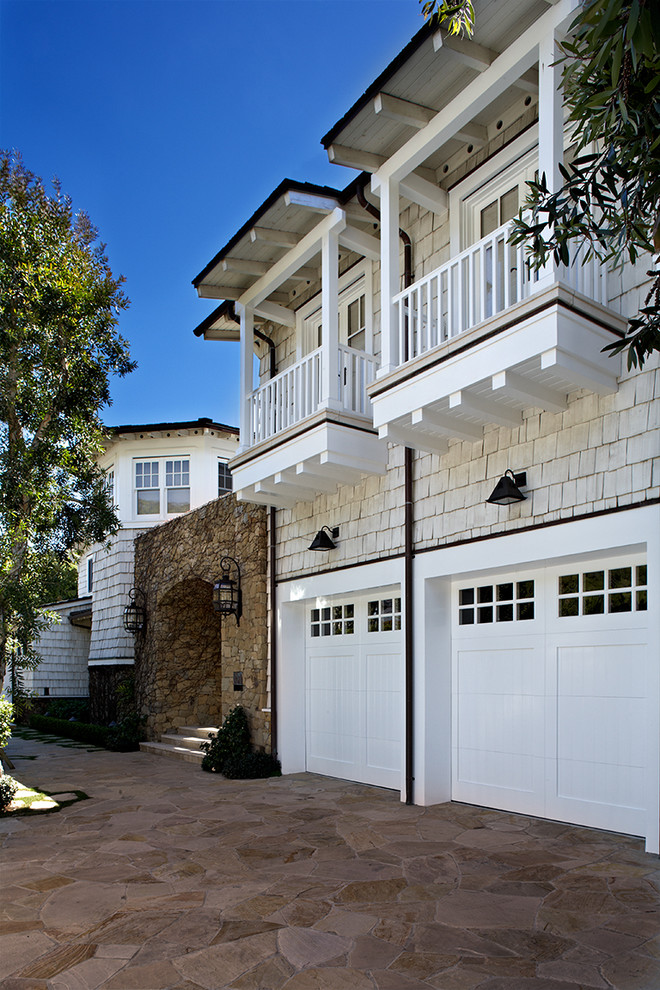 Photo of a beach style attached two-car garage in Los Angeles.