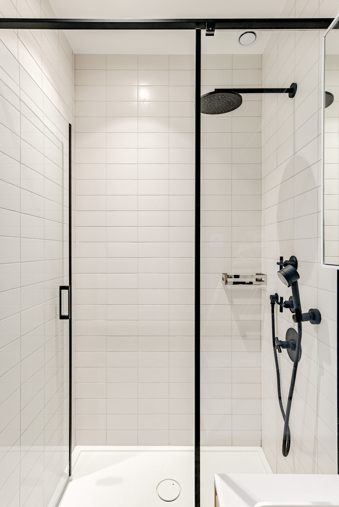 Photo of a small scandinavian 3/4 bathroom in Paris with beaded inset cabinets, light wood cabinets, a corner shower, white tile, subway tile, white walls, concrete floors, a drop-in sink, solid surface benchtops, grey floor, a hinged shower door and white benchtops.