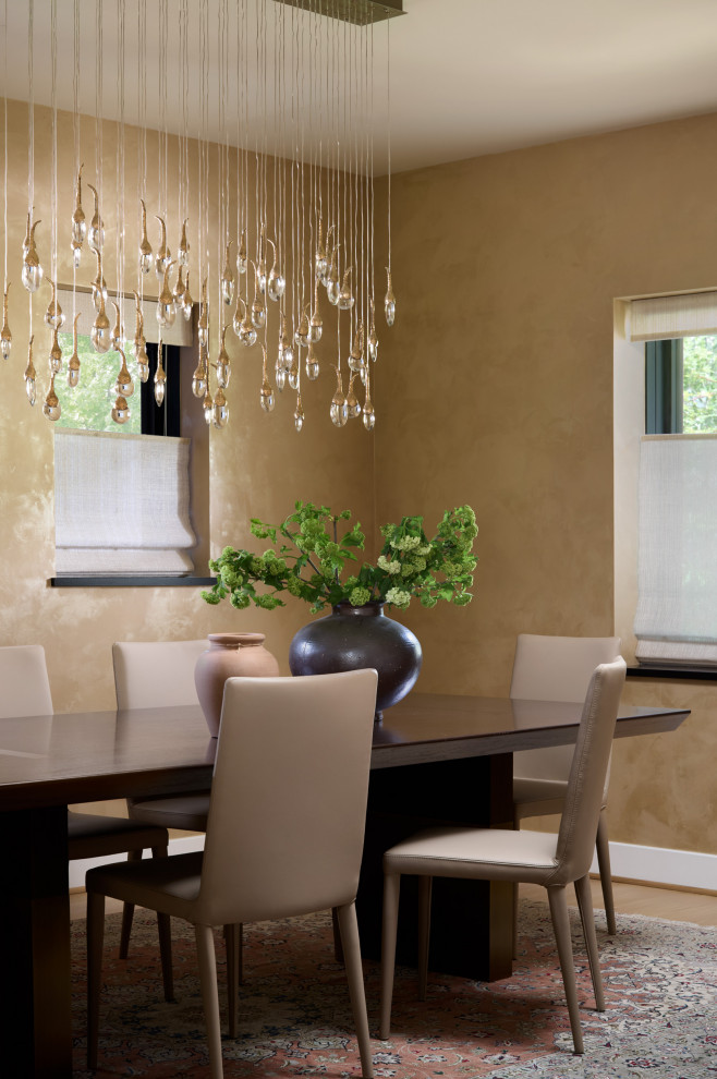 Example of a trendy medium tone wood floor and brown floor dining room design with beige walls