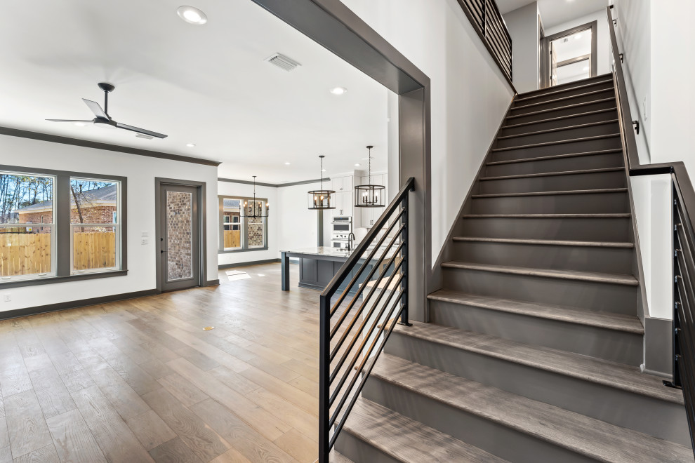 Mid-sized transitional wooden straight metal railing staircase photo with painted risers