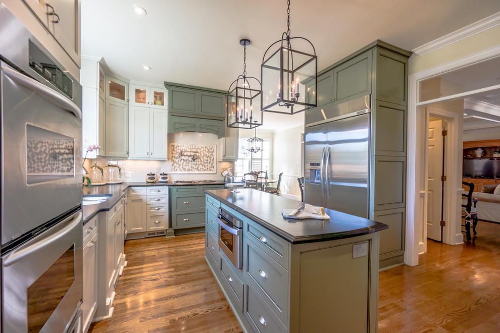 Design ideas for a transitional u-shaped eat-in kitchen in Raleigh with an undermount sink, recessed-panel cabinets, white cabinets, soapstone benchtops, white splashback, subway tile splashback and stainless steel appliances.