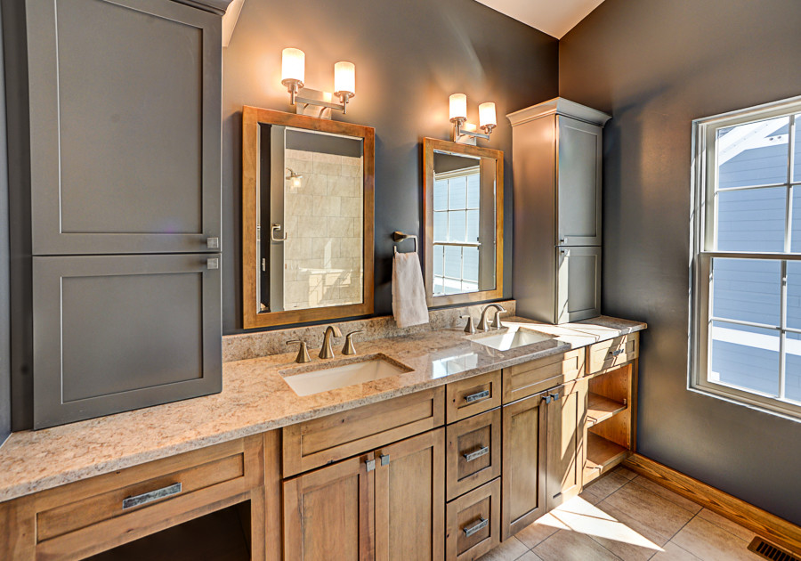 This is an example of a large country master bathroom in New York with flat-panel cabinets, medium wood cabinets, an open shower, a two-piece toilet, beige tile, ceramic tile, blue walls, ceramic floors, an undermount sink, quartzite benchtops, brown floor and a hinged shower door.