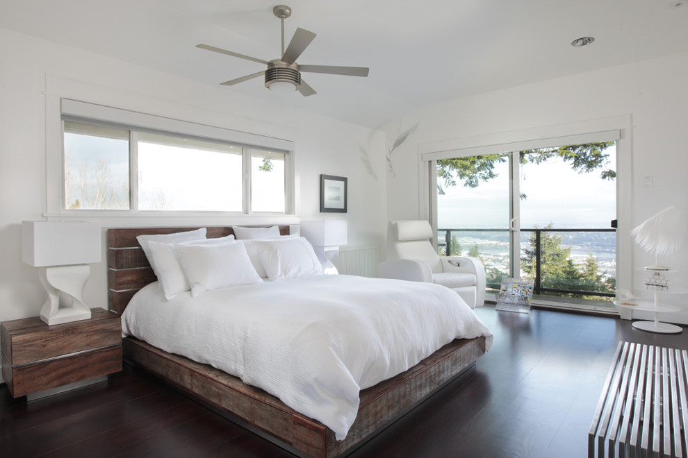 Inspiration for a contemporary bedroom in Portland with white walls and dark hardwood floors.