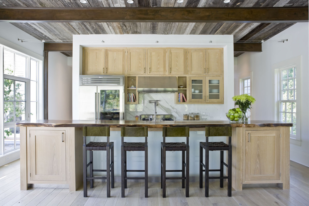 This is an example of a country kitchen in New York with stainless steel appliances.