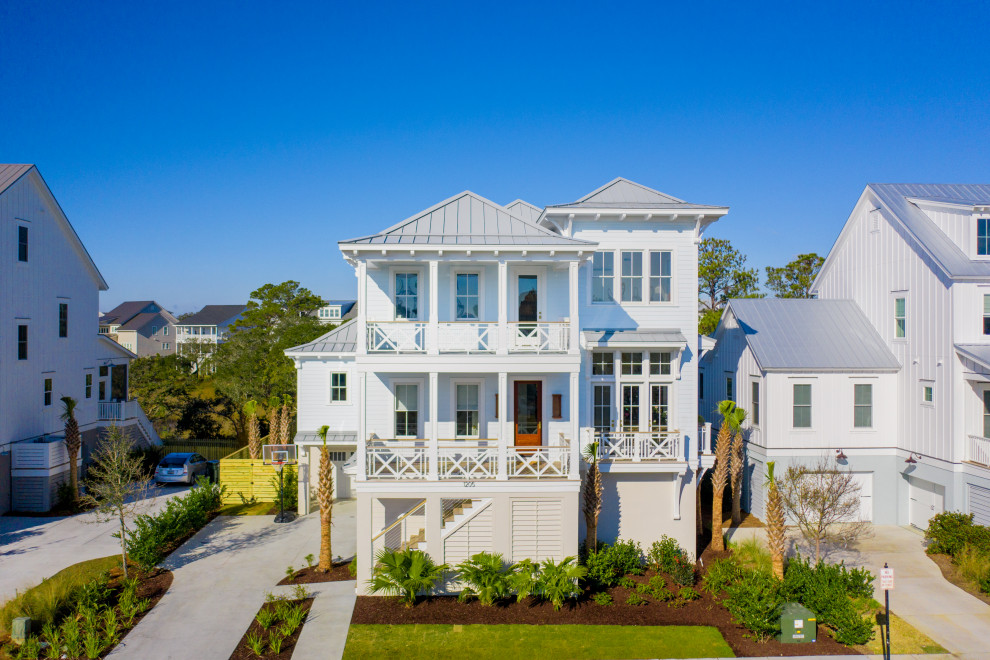 Design ideas for an expansive beach style blue house exterior in Charleston with four or more storeys, a metal roof and a grey roof.