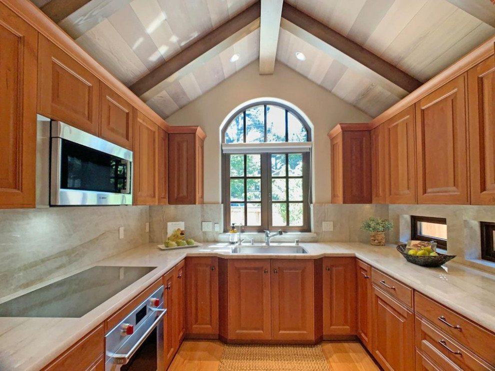 Kitchen - transitional exposed beam kitchen idea with an undermount sink, shaker cabinets, light wood cabinets and stainless steel appliances