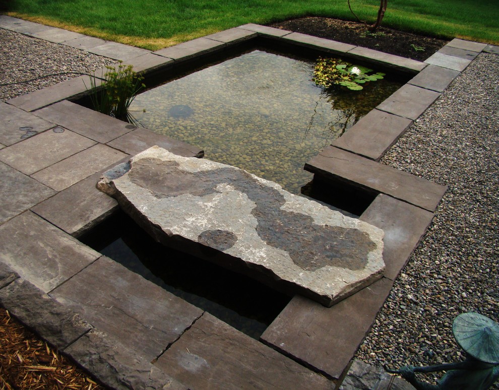 Photo of a mid-sized asian backyard partial sun formal garden in Toronto with with pond and gravel.