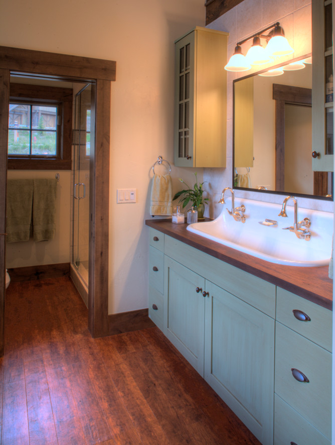 Mid-sized transitional master bathroom in Denver with shaker cabinets, green cabinets, beige tile, beige walls, medium hardwood floors, a trough sink, wood benchtops, brown floor and brown benchtops.