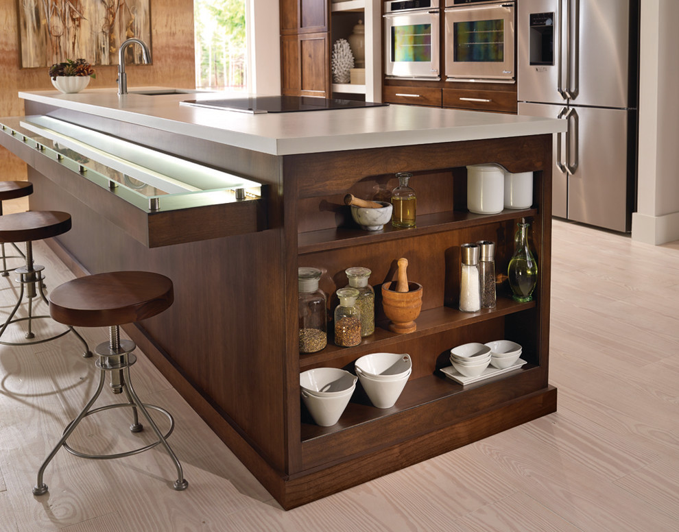 Large transitional single-wall light wood floor open concept kitchen photo with an island, an undermount sink, recessed-panel cabinets, medium tone wood cabinets and stainless steel appliances