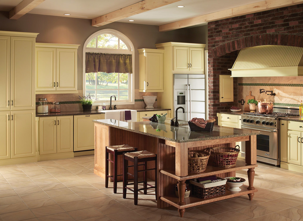 Inspiration for a transitional l-shaped eat-in kitchen remodel in Baltimore with raised-panel cabinets, yellow cabinets, quartz countertops and stainless steel appliances