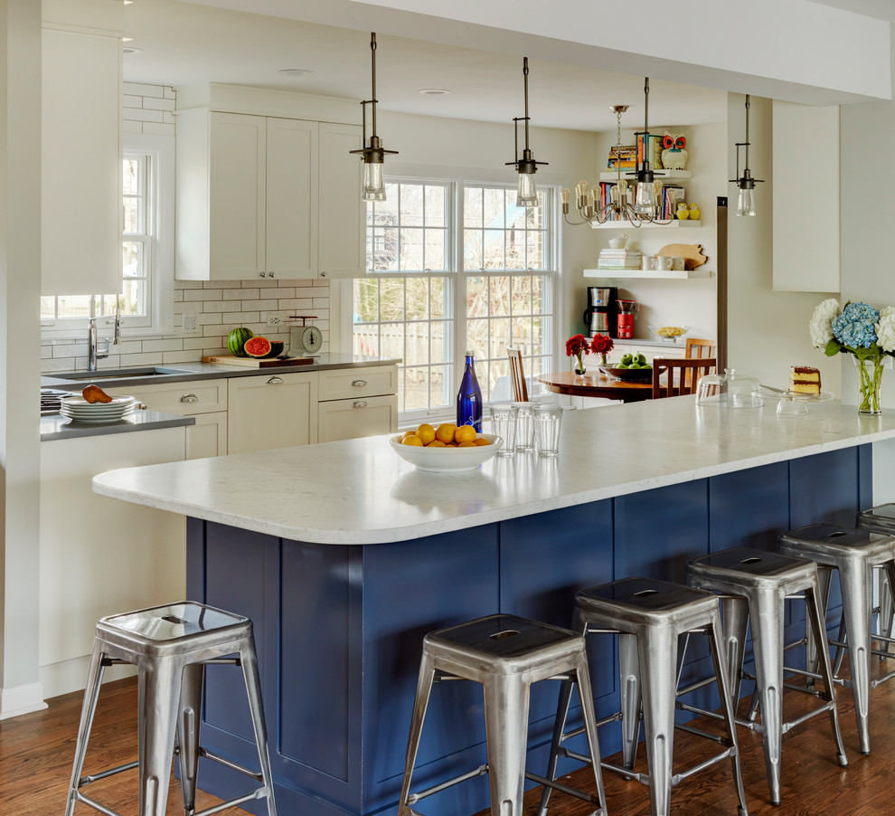 Transitional dark wood floor kitchen photo in Chicago with a single-bowl sink, shaker cabinets, blue cabinets, quartz countertops, white backsplash, ceramic backsplash, paneled appliances and an island