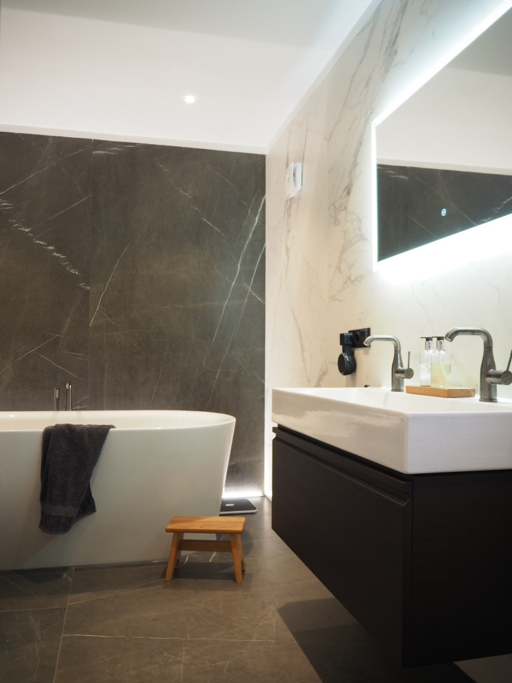 Inspiration for a mid-sized modern black and white tile and ceramic tile ceramic tile, gray floor and double-sink freestanding bathtub remodel in Munich with flat-panel cabinets, dark wood cabinets, white walls, a console sink and a floating vanity