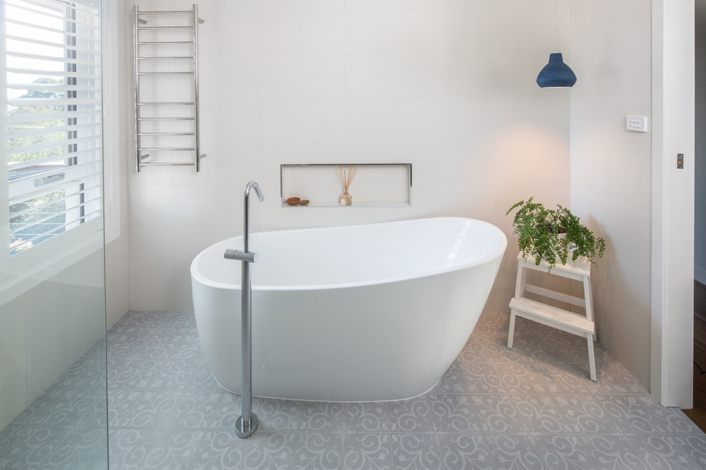 Inspiration for a mid-sized contemporary bathroom in Brisbane with flat-panel cabinets, medium wood cabinets, a freestanding tub, an open shower, white tile, porcelain tile, white walls, porcelain floors, an undermount sink, engineered quartz benchtops, grey floor, an open shower and white benchtops.