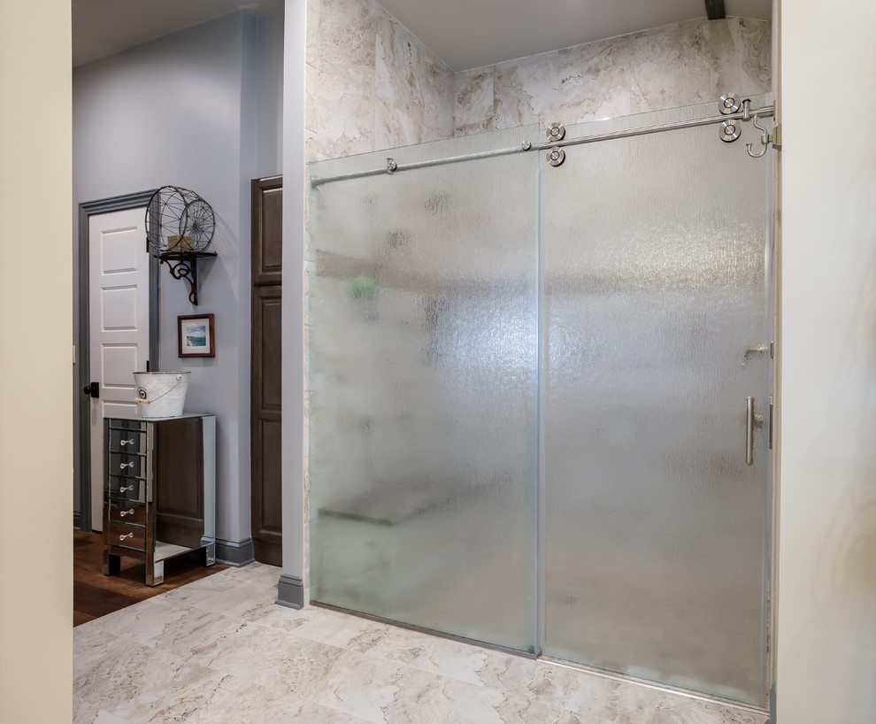This is an example of a large master bathroom in Jacksonville with recessed-panel cabinets, brown cabinets, a corner shower, a one-piece toilet, brown tile, porcelain tile, green walls, porcelain floors, a vessel sink, engineered quartz benchtops, brown floor, a hinged shower door and multi-coloured benchtops.