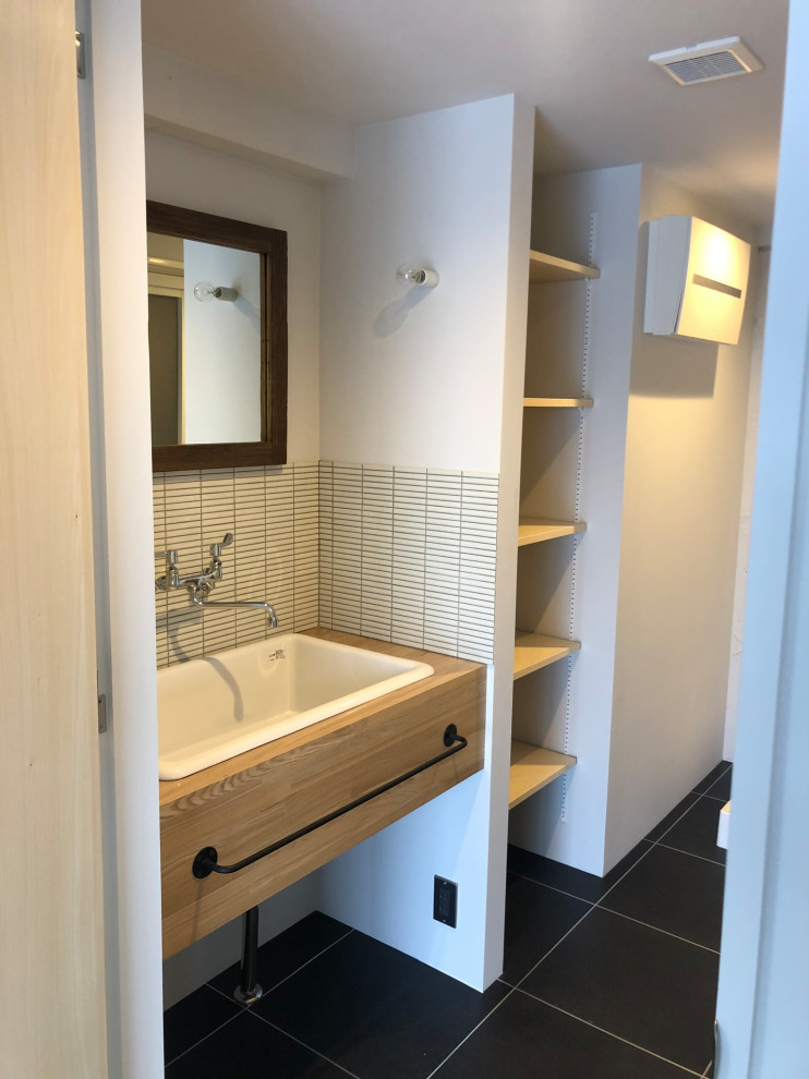 Inspiration for a small modern cloakroom in Tokyo Suburbs with open cabinets, white tiles, ceramic tiles, lino flooring, wooden worktops, black floors, a built in vanity unit, a timber clad ceiling and tongue and groove walls.