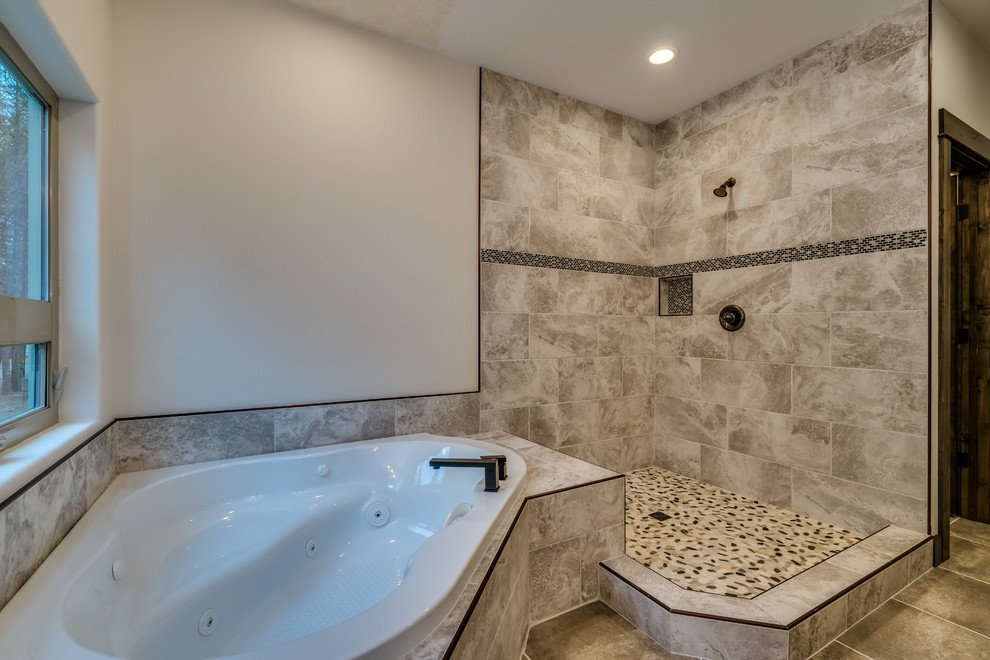 This is an example of a large country master bathroom in Other with a corner tub, a corner shower, beige tile, ceramic tile, ceramic floors, beige floor and a sliding shower screen.