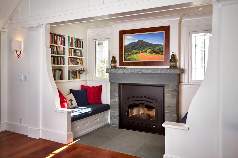Design ideas for a traditional living room in San Francisco with white walls, a standard fireplace and a stone fireplace surround.