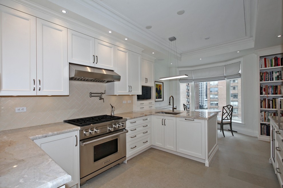 Enclosed kitchen - large transitional u-shaped limestone floor and beige floor enclosed kitchen idea in Toronto with an undermount sink, recessed-panel cabinets, white cabinets, granite countertops, beige backsplash, ceramic backsplash, paneled appliances and a peninsula