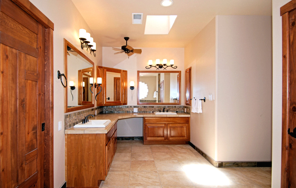 Inspiration for a mid-sized asian master bathroom in Portland with raised-panel cabinets, medium wood cabinets, an alcove tub, an alcove shower, a one-piece toilet, mosaic tile, white walls and a drop-in sink.