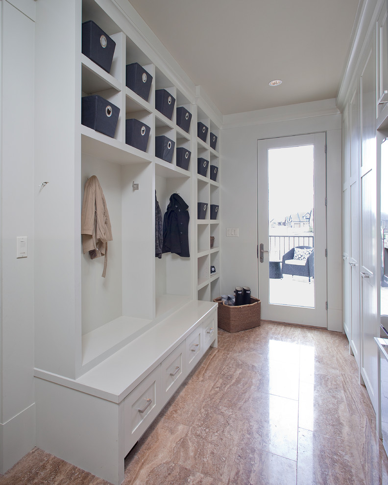 Photo of a traditional mudroom in Calgary with white walls.