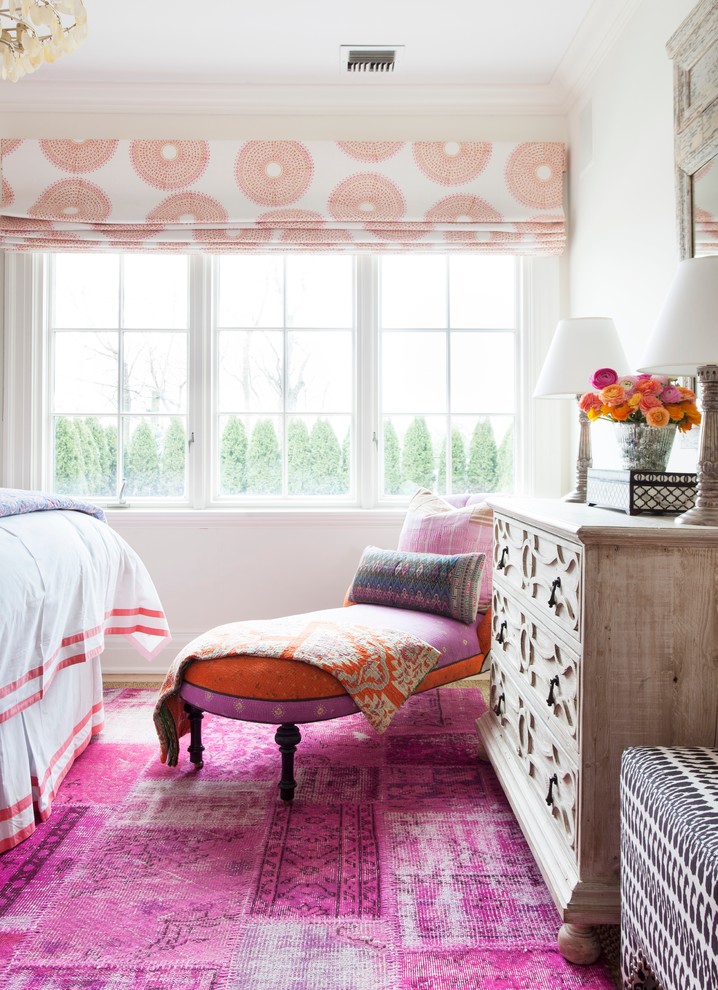 Mid-sized eclectic master bedroom in New York with white walls, pink floor and carpet.