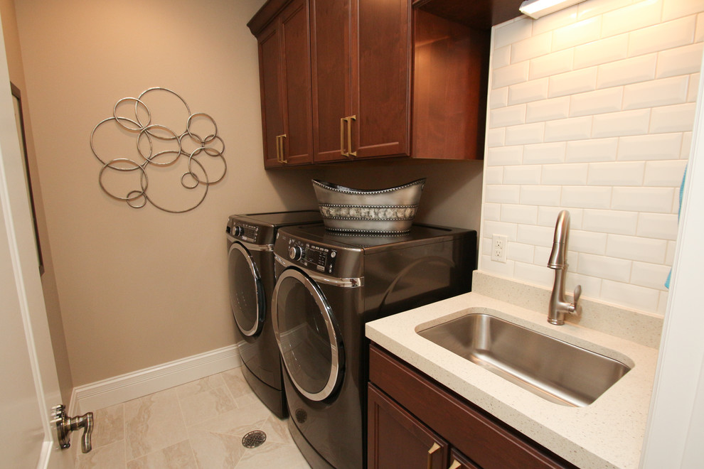 Inspiration for a galley dedicated laundry room in Milwaukee with an undermount sink, recessed-panel cabinets, medium wood cabinets, quartz benchtops and a side-by-side washer and dryer.