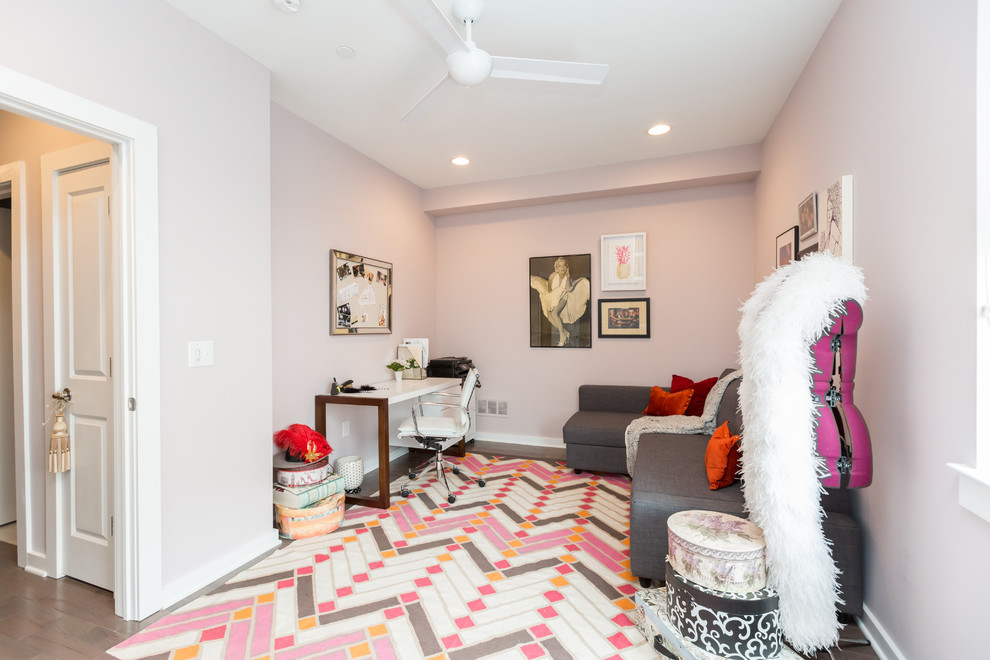 Photo of a mid-sized modern study room in Philadelphia with pink walls, medium hardwood floors, a freestanding desk and pink floor.