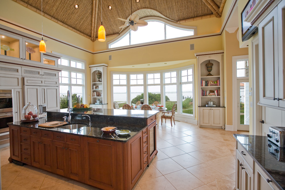 Transitional u-shaped porcelain tile and beige floor eat-in kitchen photo with an island, an undermount sink, recessed-panel cabinets, gray cabinets, granite countertops, paneled appliances and black countertops
