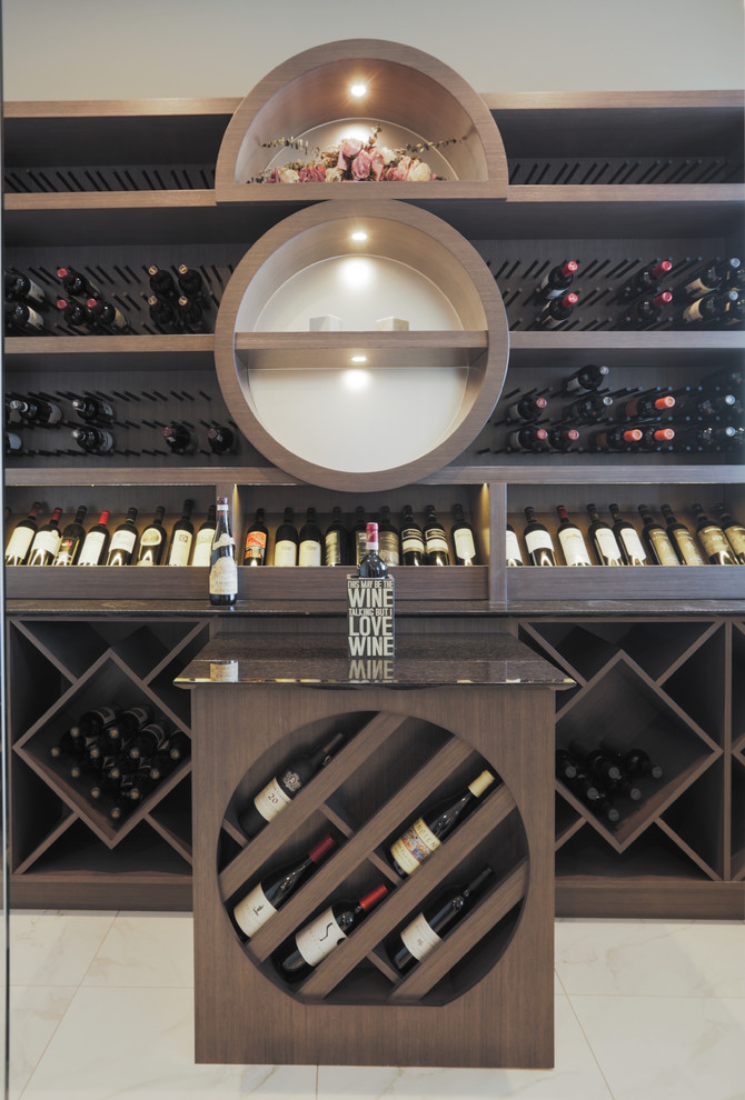 Inspiration for a mid-sized contemporary wine cellar in Calgary with porcelain floors and display racks.