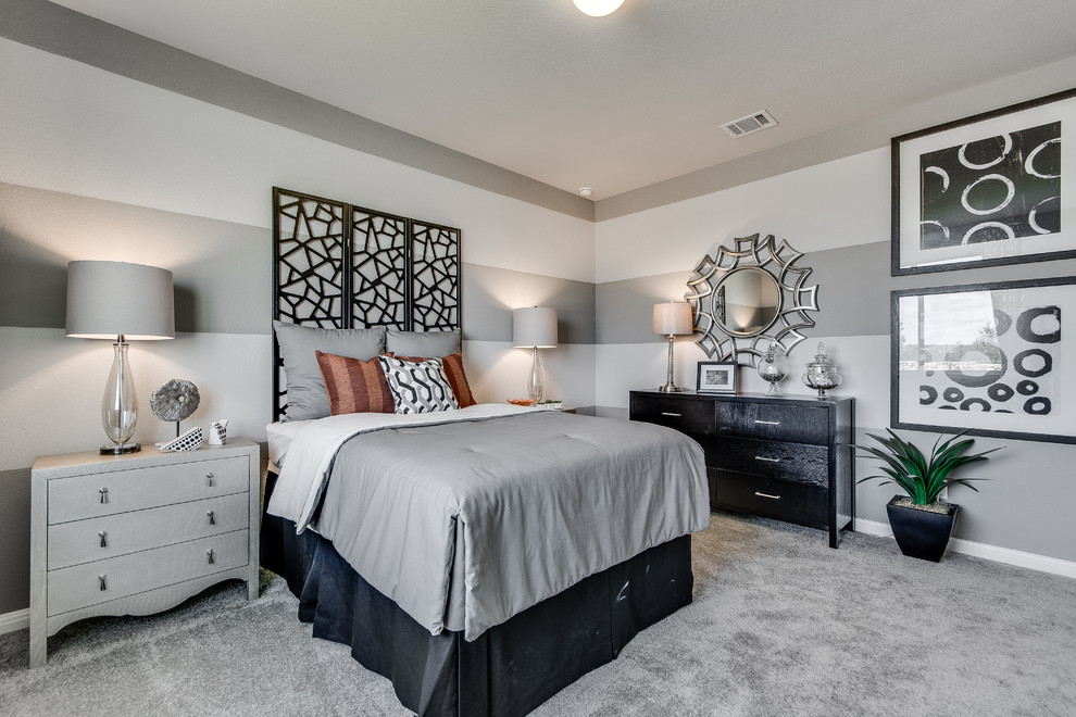Photo of a contemporary bedroom in Austin with grey walls, carpet and grey floor.