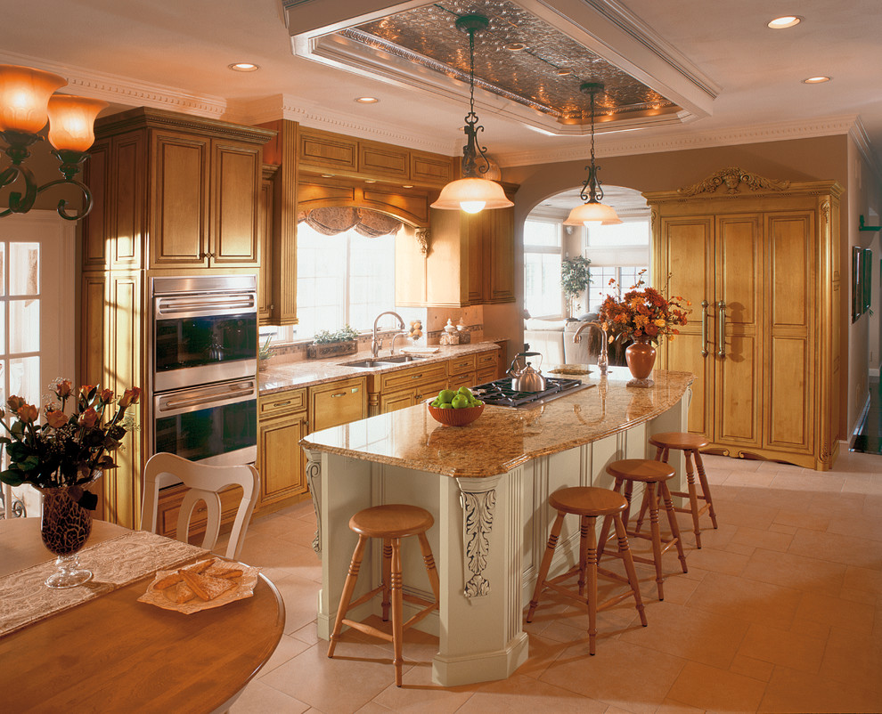 Inspiration for a large mediterranean l-shaped eat-in kitchen in Baltimore with with island, granite benchtops, stainless steel appliances and medium wood cabinets.