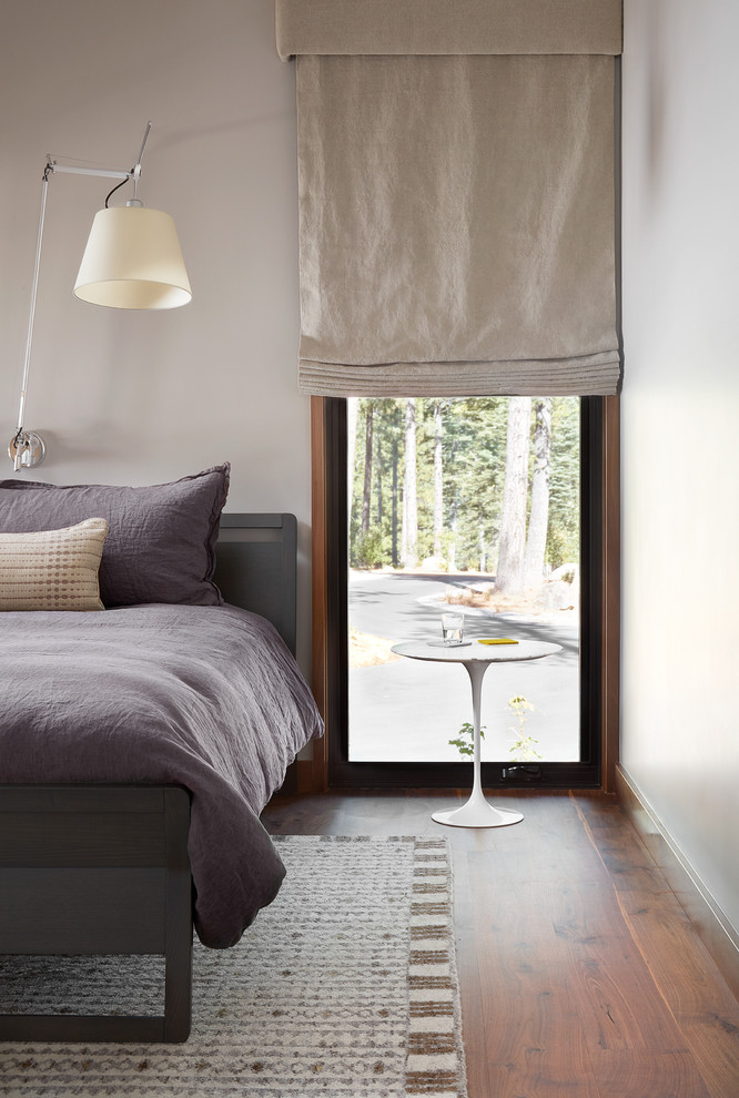 Example of a large minimalist guest dark wood floor and brown floor bedroom design in San Francisco with gray walls and no fireplace