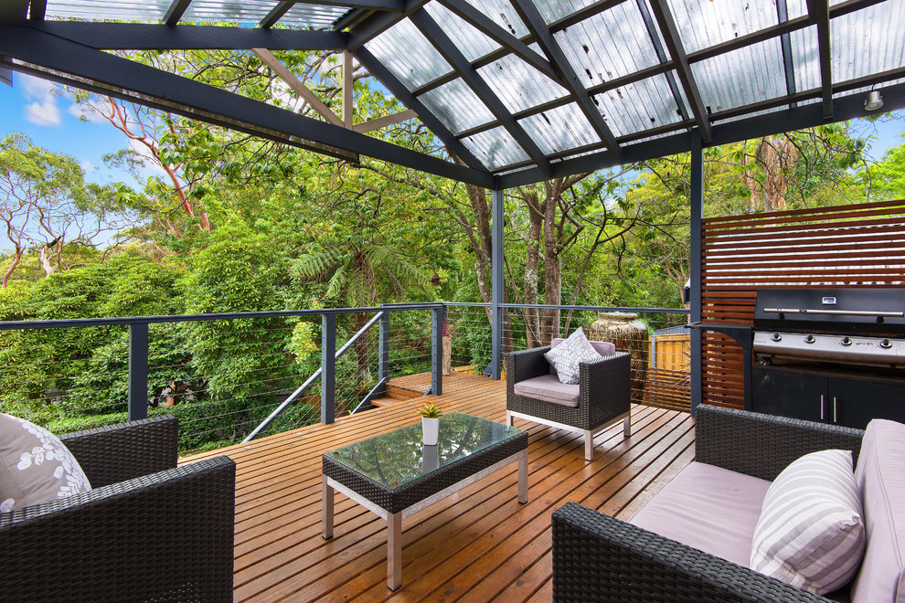 Photo of a modern backyard deck in Sunshine Coast with a pergola.