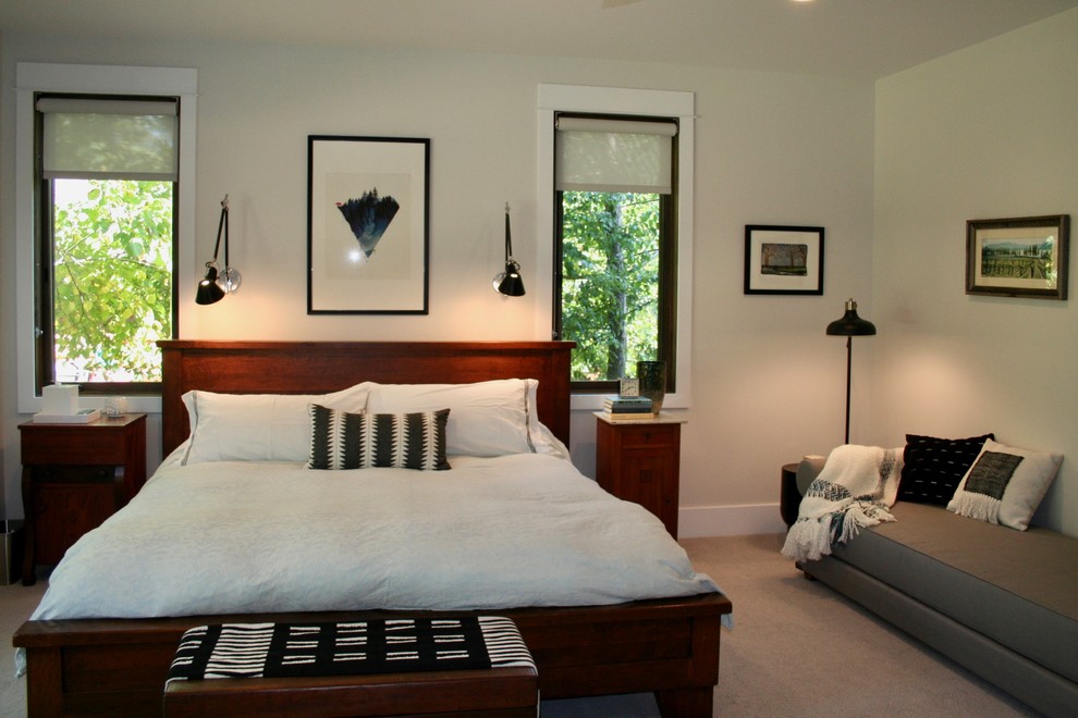 Large contemporary guest bedroom in Other with white walls, carpet and beige floor.