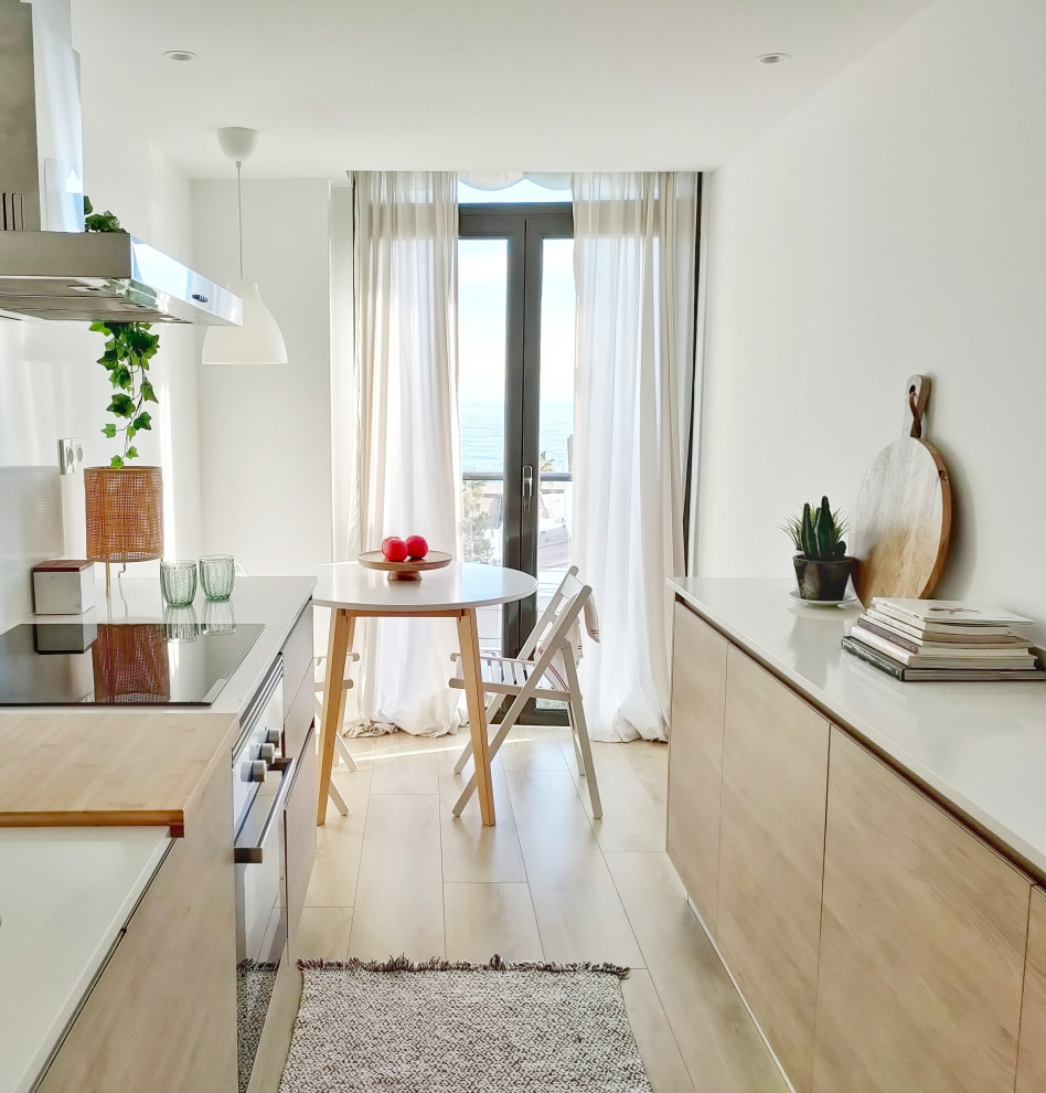 Design ideas for a small scandi enclosed kitchen in Barcelona with flat-panel cabinets, medium wood cabinets, engineered stone countertops, stainless steel appliances, light hardwood flooring, no island, brown floors and white worktops.