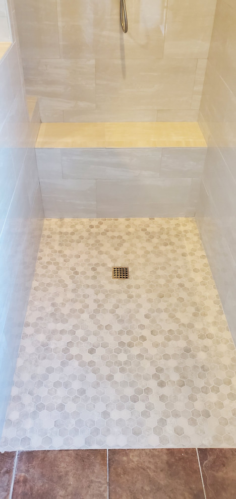 This is an example of a mid-sized contemporary master bathroom in Dallas with a corner tub, a curbless shower, beige tile, porcelain tile, limestone floors, multi-coloured floor, an open shower and a shower seat.