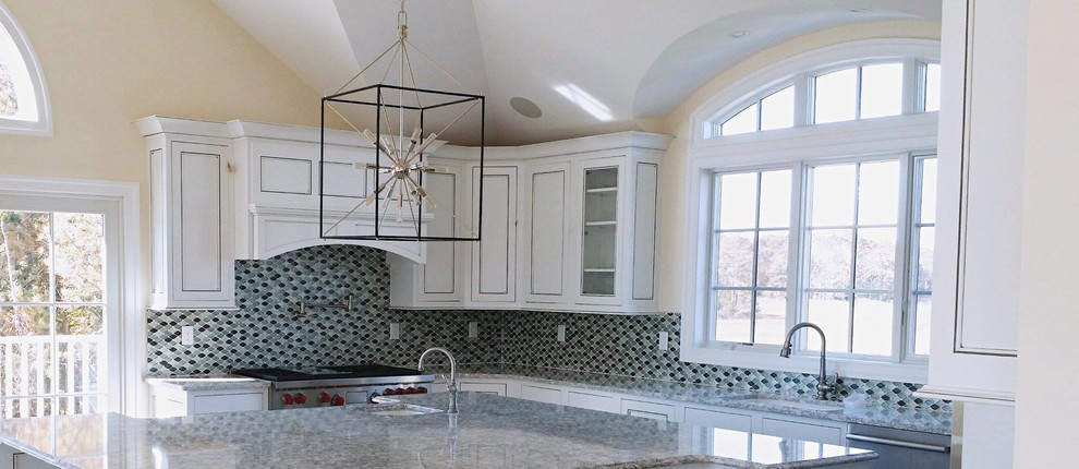 Eat-in kitchen - large transitional u-shaped dark wood floor eat-in kitchen idea with a drop-in sink, raised-panel cabinets, white cabinets, granite countertops, blue backsplash, mosaic tile backsplash, stainless steel appliances and an island