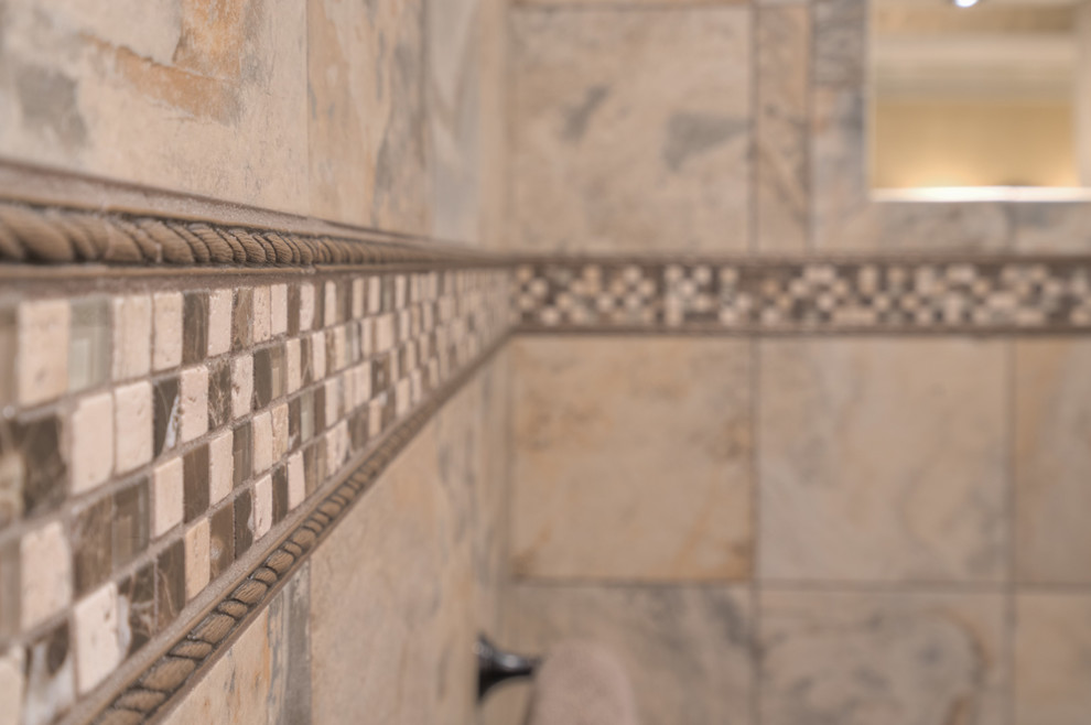 Inspiration for a mid-sized transitional master multicolored tile ceramic tile home design remodel with raised-panel cabinets, beige cabinets, a two-piece toilet, beige walls, an undermount sink and quartz countertops