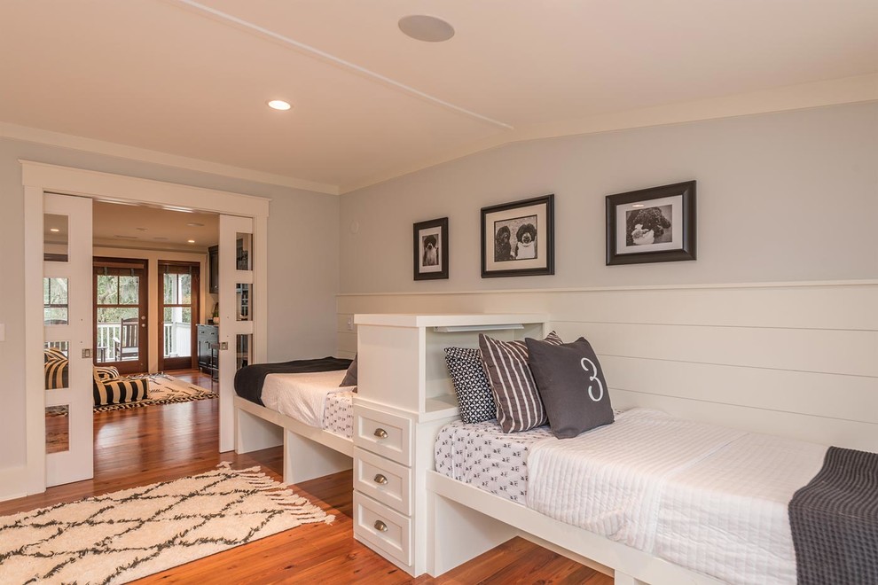 Photo of a large beach style gender-neutral kids' bedroom in Atlanta with grey walls, medium hardwood floors and brown floor.