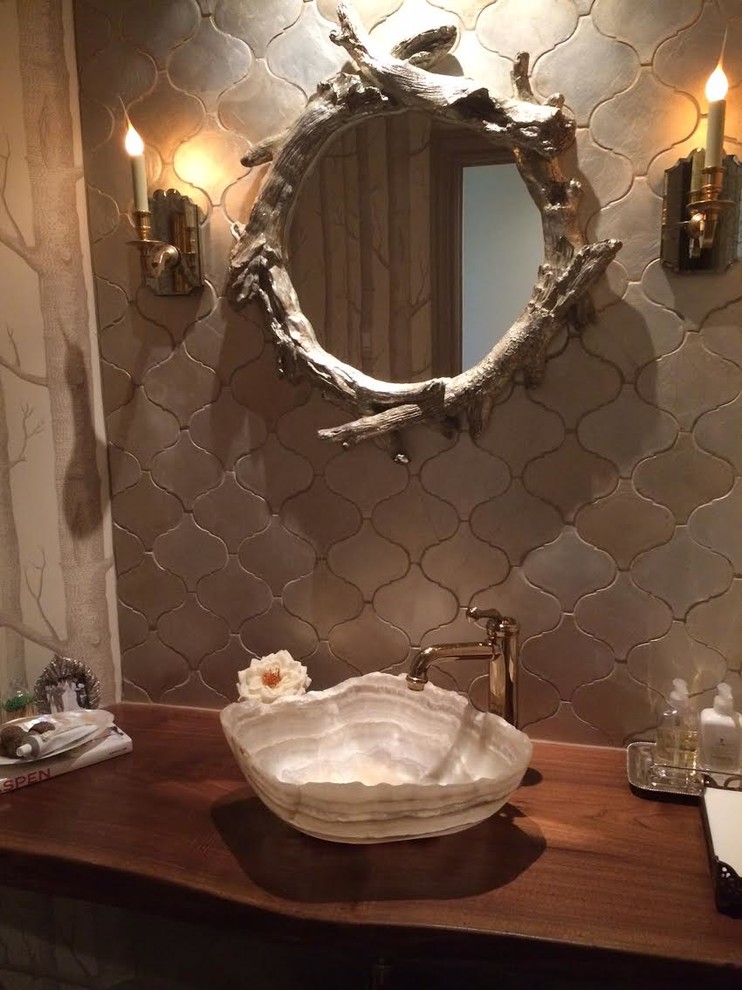 This is an example of a small country powder room in Atlanta with brown walls, a vessel sink and wood benchtops.