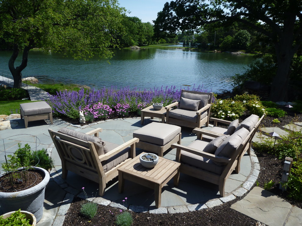 Inspiration for a traditional backyard patio in Portland Maine with natural stone pavers and no cover.
