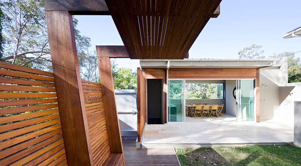 Design ideas for a contemporary exterior in Brisbane with wood siding and a flat roof.