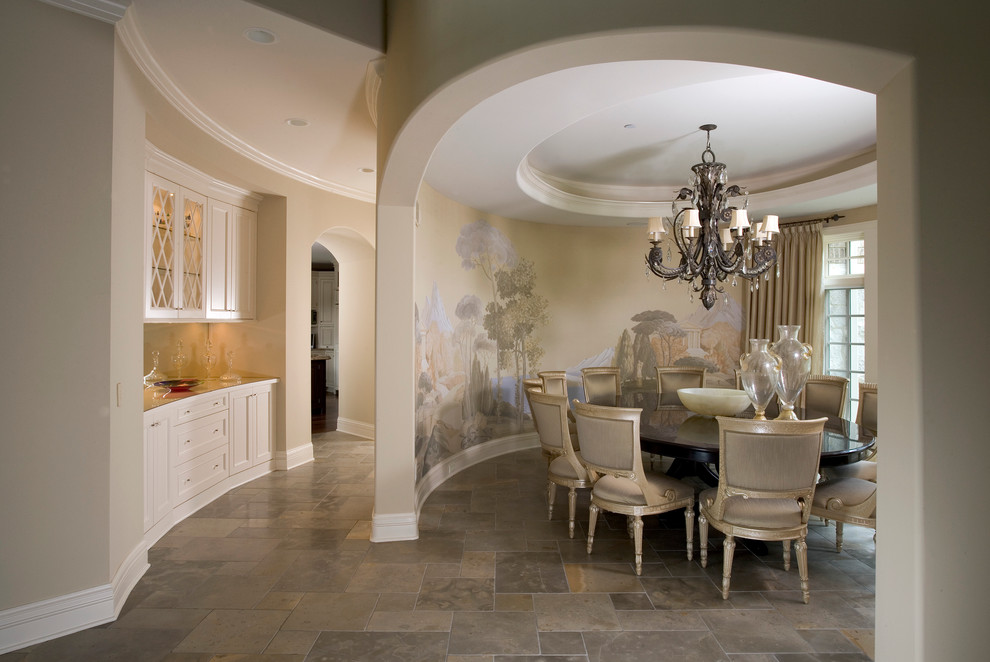 This is an example of an expansive traditional dining room in Chicago with beige walls and limestone floors.