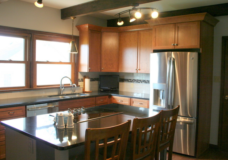 Kitchen - mid-sized transitional l-shaped medium tone wood floor kitchen idea with an undermount sink, recessed-panel cabinets, medium tone wood cabinets, granite countertops, white backsplash, ceramic backsplash, stainless steel appliances and an island