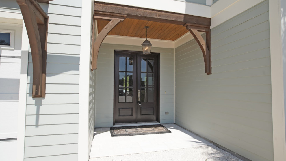 This is an example of a beach style front door in Other with grey walls, a double front door and a black front door.
