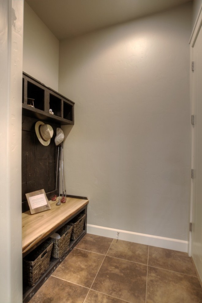 Inspiration for a transitional porcelain tile and beige floor mudroom remodel in Boise with gray walls