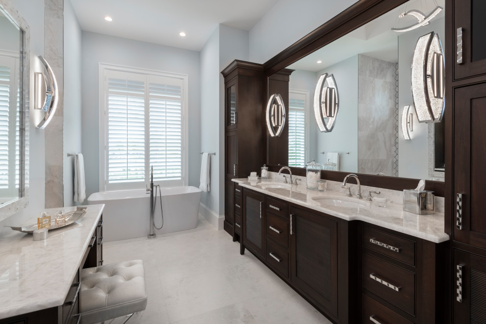 This is an example of a large beach style master bathroom in Other with beaded inset cabinets, dark wood cabinets, a freestanding tub, grey walls, an undermount sink, grey floor, white benchtops, a double vanity, a built-in vanity, blue tile, marble floors and quartzite benchtops.