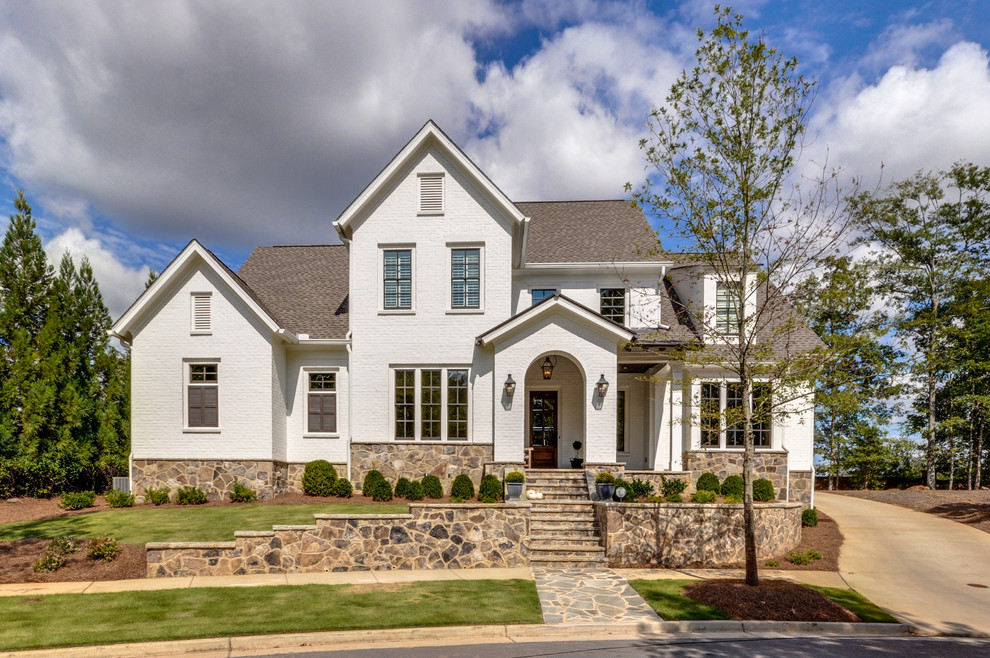 This is an example of a contemporary two-storey brick white house exterior in Atlanta.